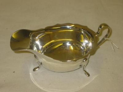 Appraisal: A SAUCE BOAT of oval form with gimped rim raised