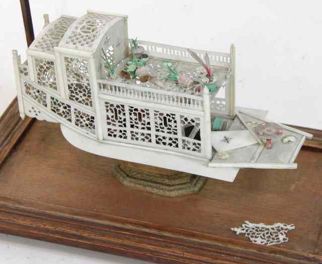 Appraisal: A Chinese ivory house boat carved and pierced with coloured