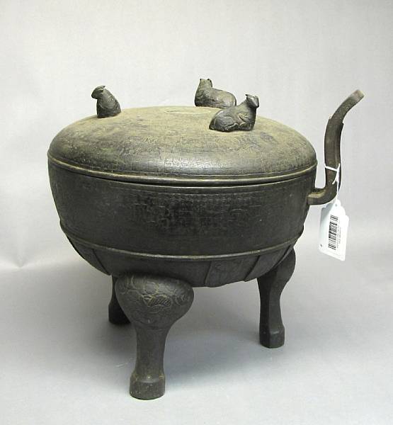 Appraisal: An archaistic cast bronze covered ding th Century Based on