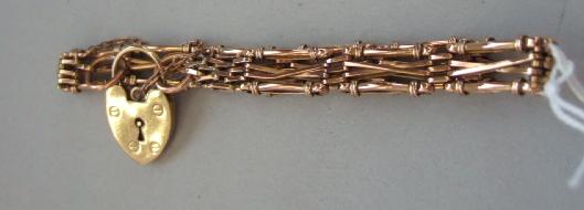 Appraisal: A gold bar twisted bar and oval link gate bracelet