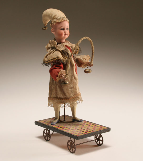 Appraisal: Bisque head doll mechanical pull toy motion causes doll to