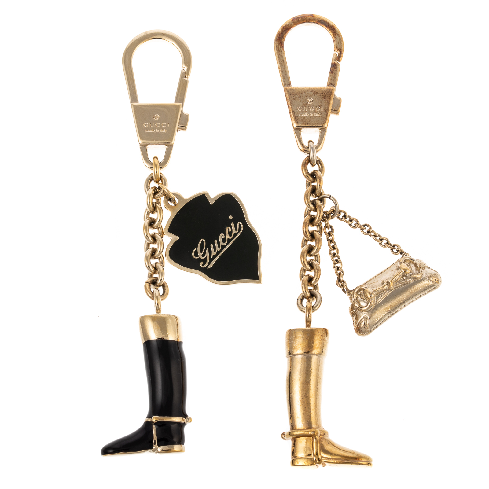 Appraisal: TWO GUCCI EQUESTRIAN BOOT KEYCHAINS A black and gold tone