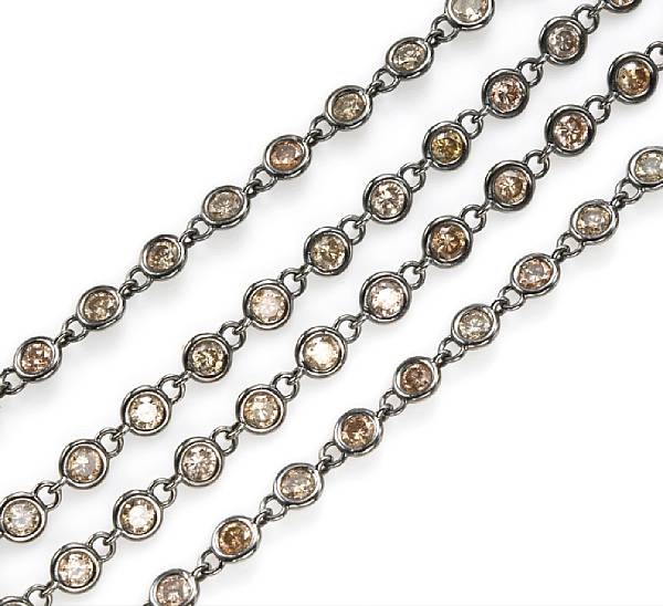 Appraisal: A colored diamond longchain necklace set throughout with light brown