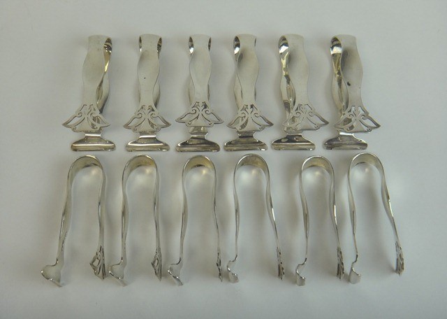 Appraisal: A set of twelve silver asparagus tongs Sheffield combined weight