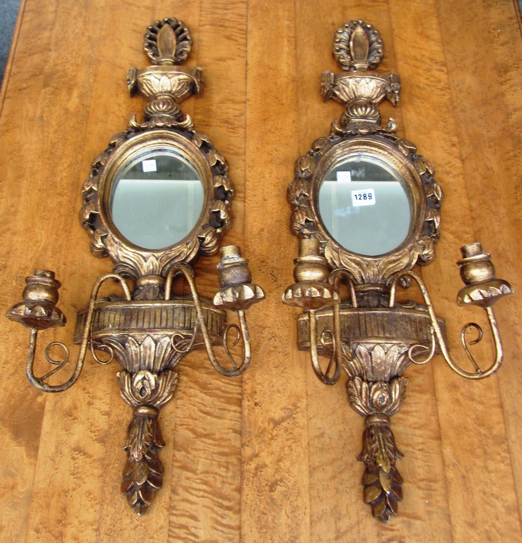 Appraisal: A pair of th century style gilt framed oval wall