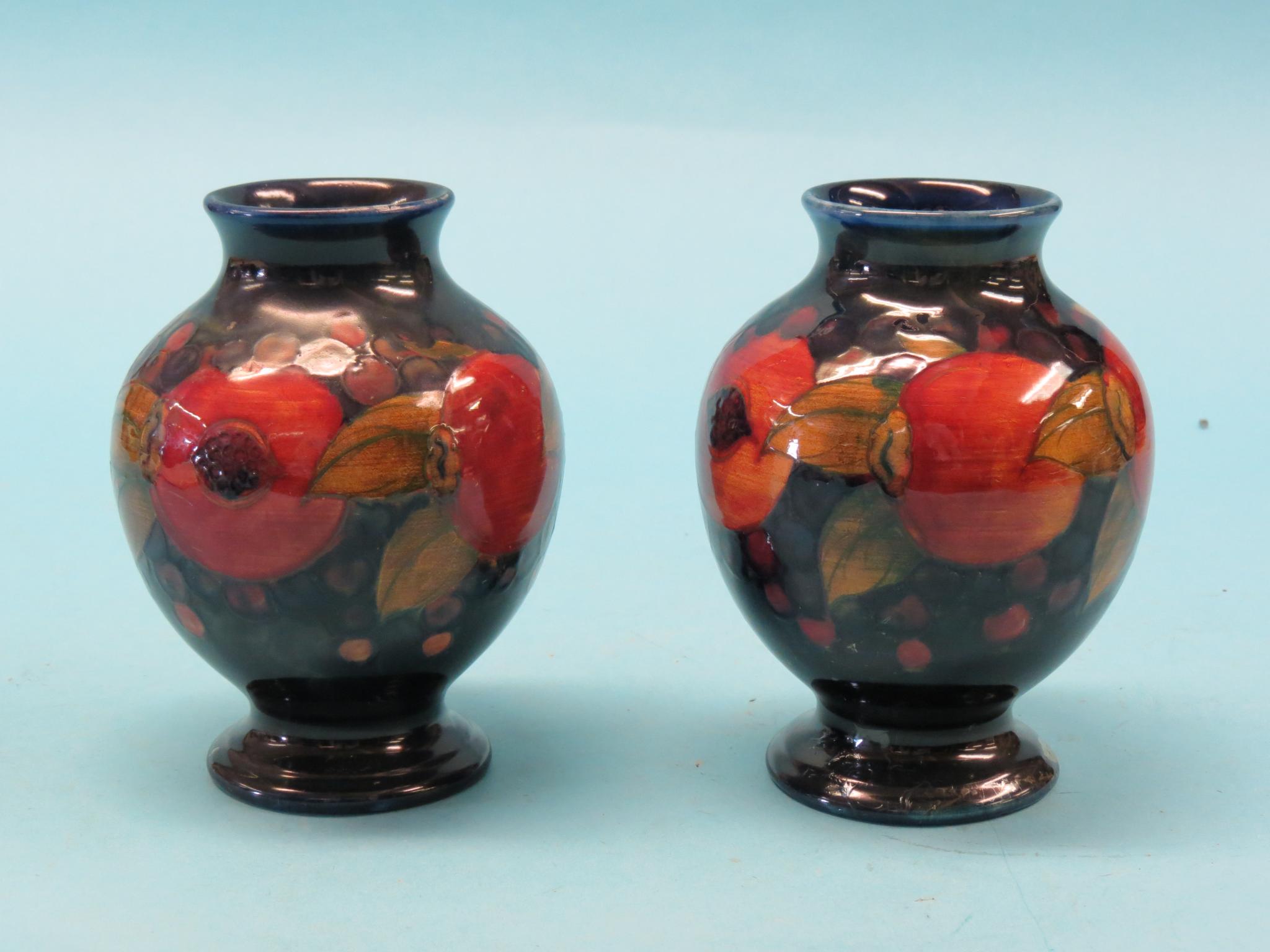 Appraisal: A pair of Moorcroft vases Pomegranate baluster-shape impressed marks and