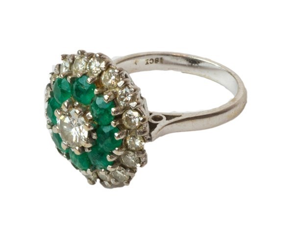 Appraisal: A white gold diamond and emerald set cluster ring claw