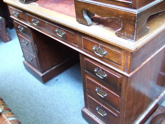 Appraisal: A late th century walnut twin pedestal desk with nine