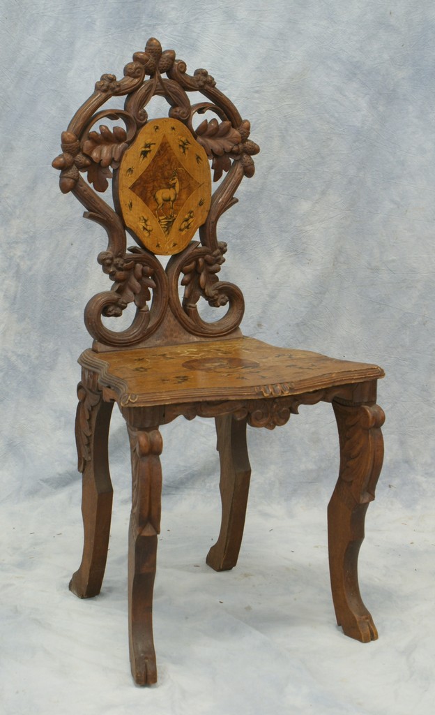 Appraisal: Carved and inlaid black forest chair with scenes of mountain