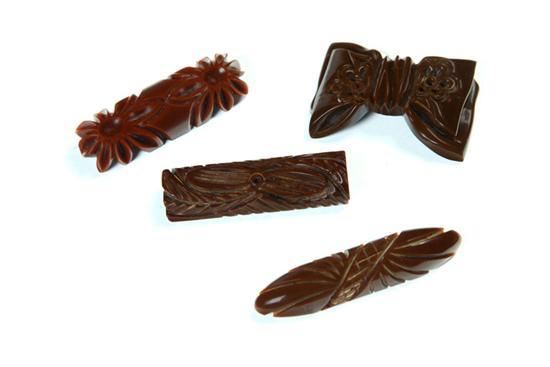 Appraisal: FOUR CARVED EARLY PLASTIC PINS American Ca - Brown bakelite