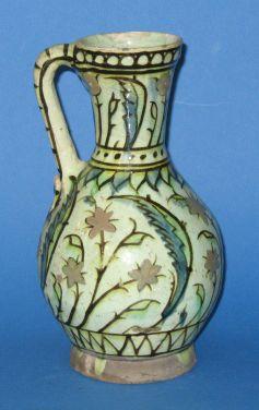 Appraisal: AN ISNIC TIN GLAZED EWER decorated in polychrome with sprays