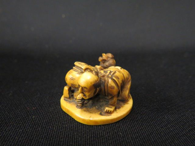 Appraisal: Carved Ivory Netsuke of Man Woman scrubbing the floor long