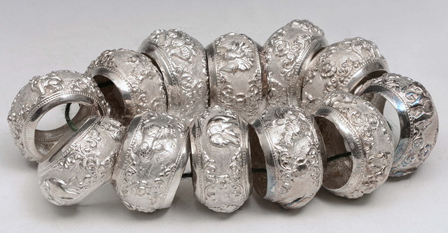 Appraisal: A COLLECTION OF TWELVE BURMESE WHITE METAL NAPKIN RINGS with