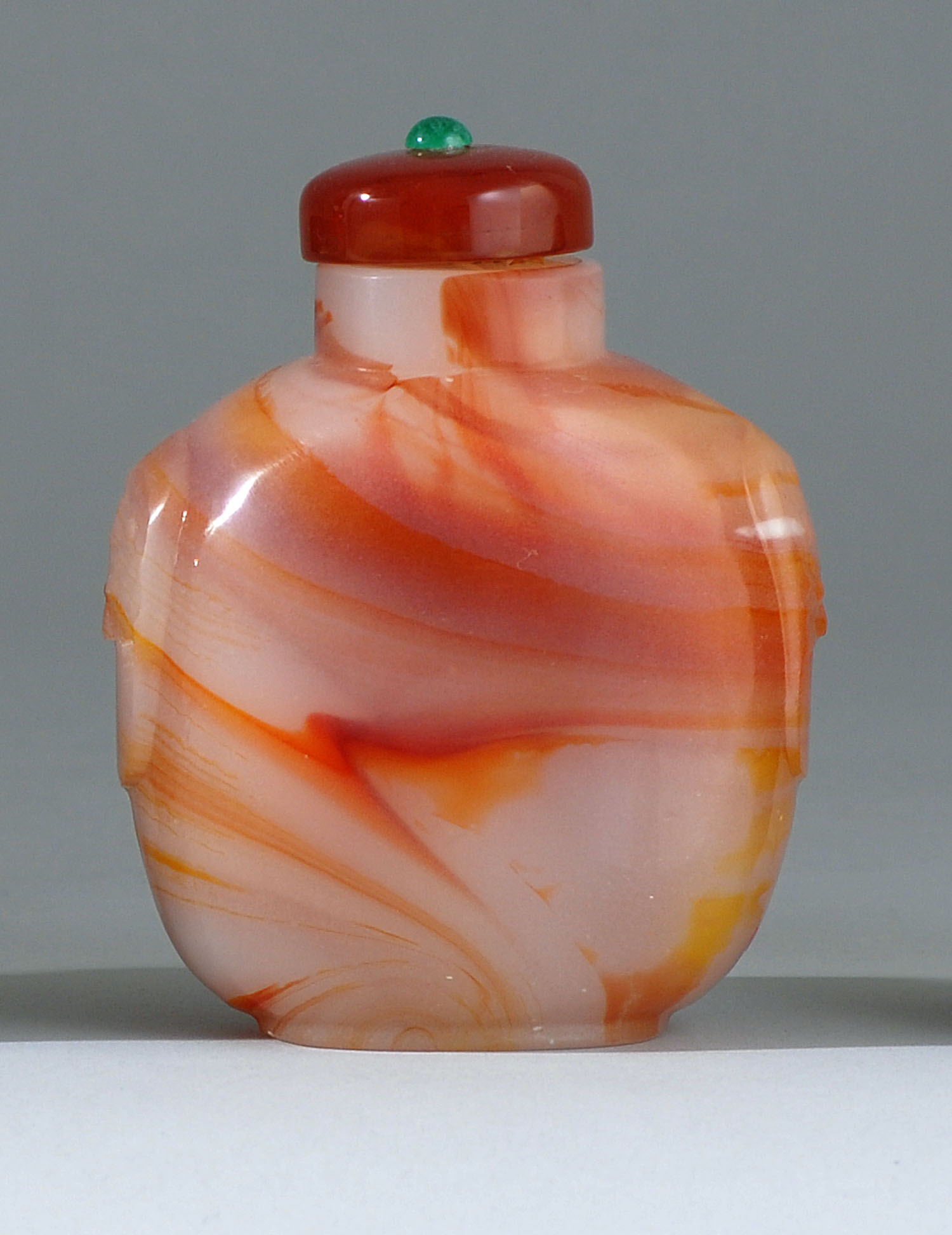 Appraisal: GLASS SNUFF BOTTLE Early th CenturySimulating carnelian agate in ovoid