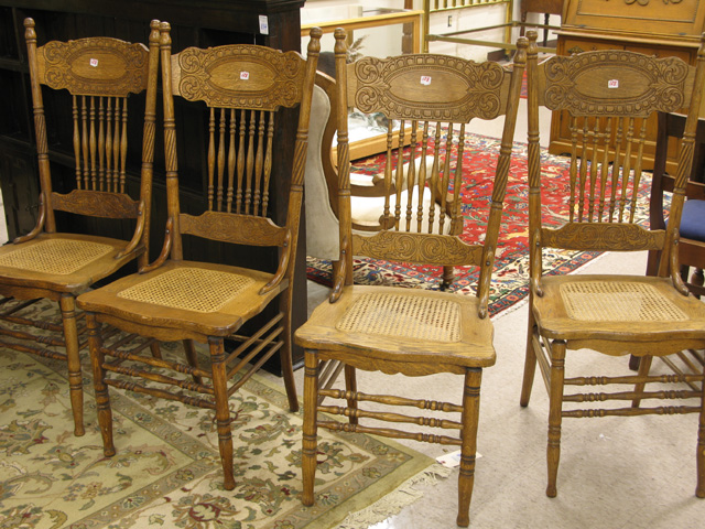 Appraisal: A SET OF FOUR OAK PRESS-BACK DINING CHAIRS American c