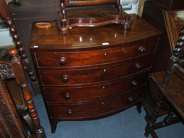 Appraisal: A late Georgian mahogany bow front chest of four long