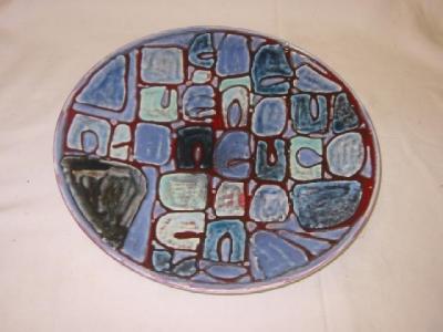 Appraisal: A POOLE POTTERY CHARGER enamelled in an abstract checkered pattern