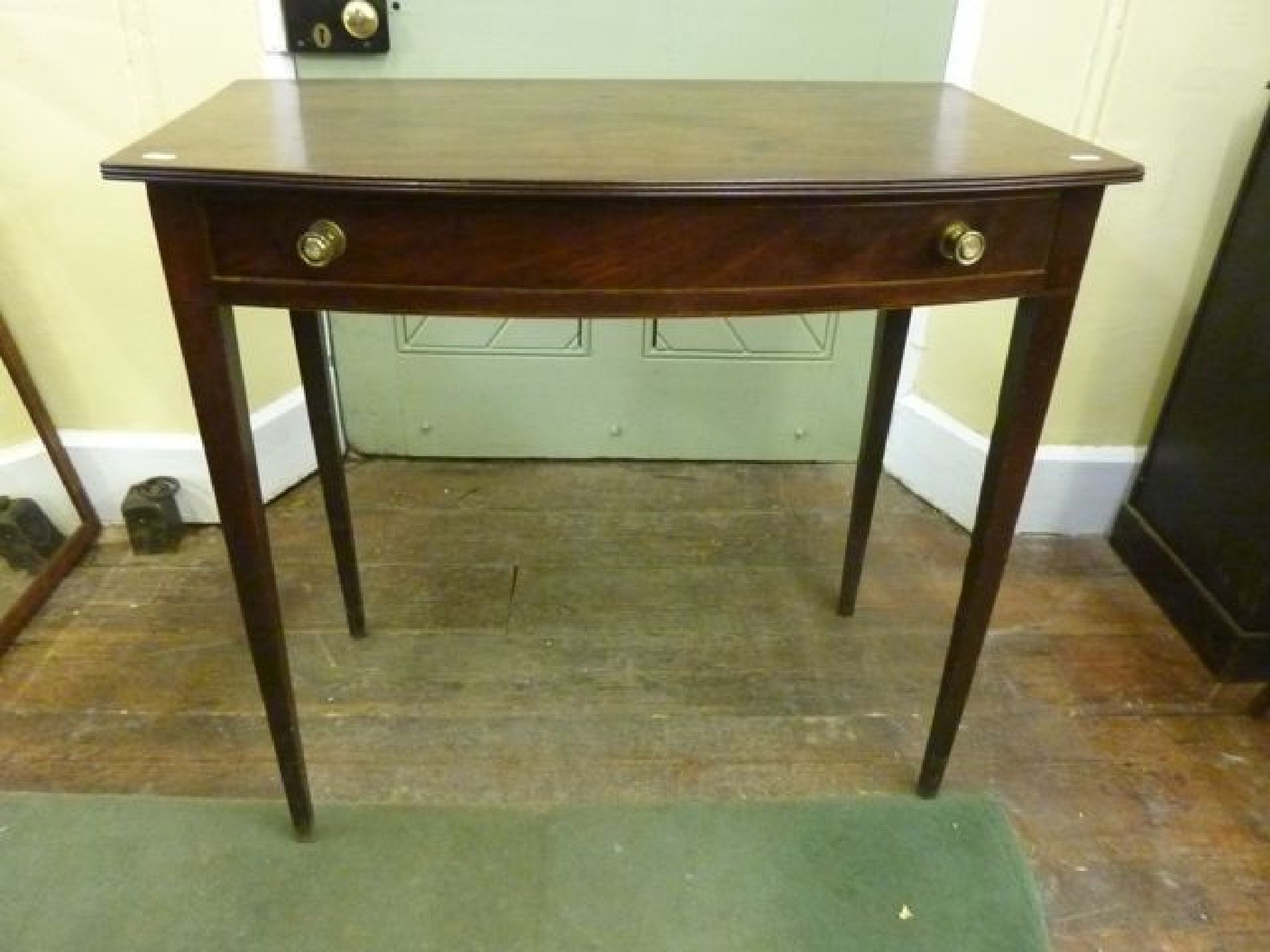 Appraisal: A simple Regency mahogany side table with bow fronted outline