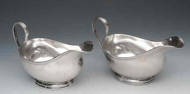 Appraisal: TWO SIMILAR SAUCE BOATS with reeded rims oval stepped bases