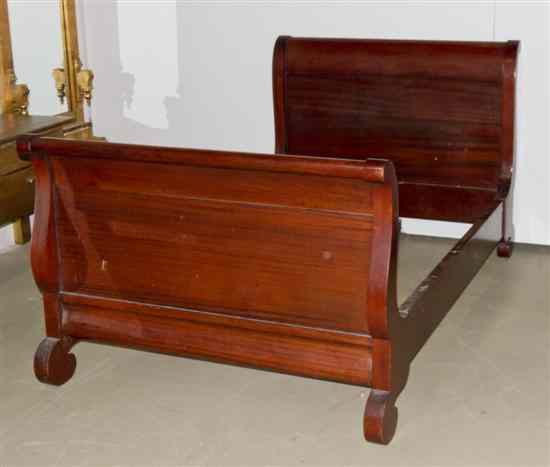 Appraisal: An American Empire Mahogany Sleigh Bed having scrolled head and