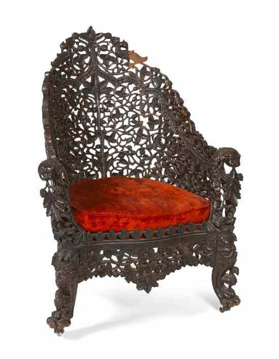 Appraisal: An Anglo-Indian Carved Armchair pierce carved throughout the leaf crest