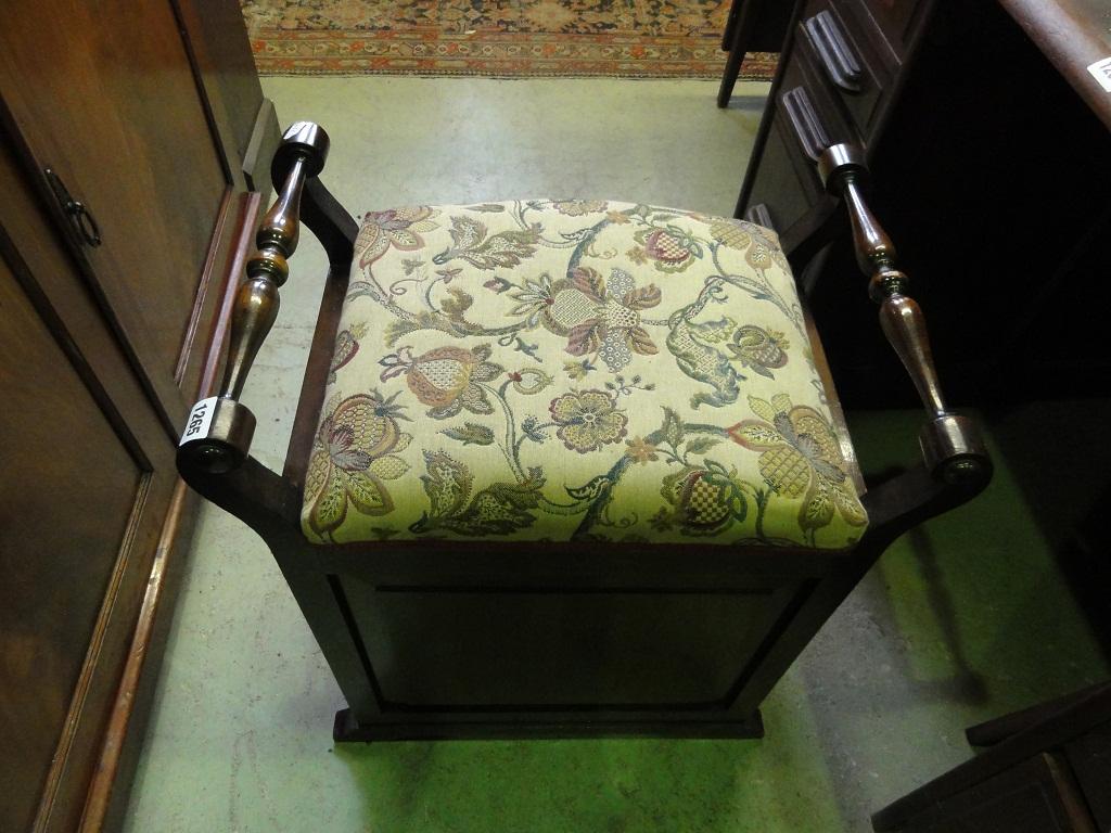 Appraisal: An Edwardian walnut piano stool with upholstered box seat within