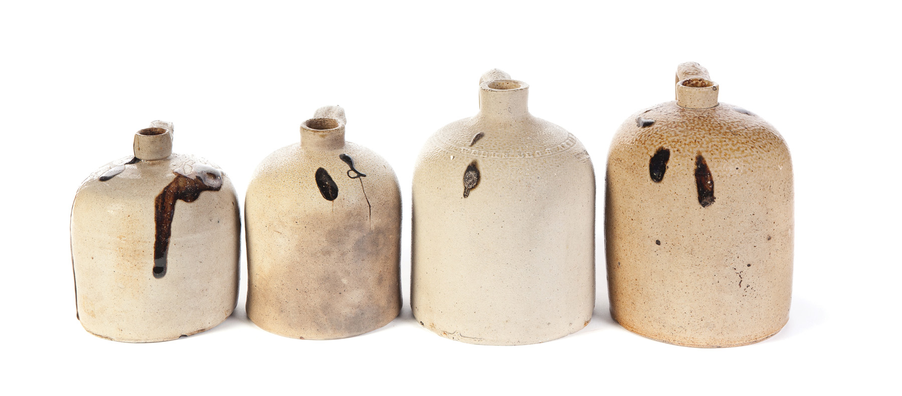 Appraisal: FOUR STONEWARE JUGS WITH TOBACCO SPIT DEC American nd half-