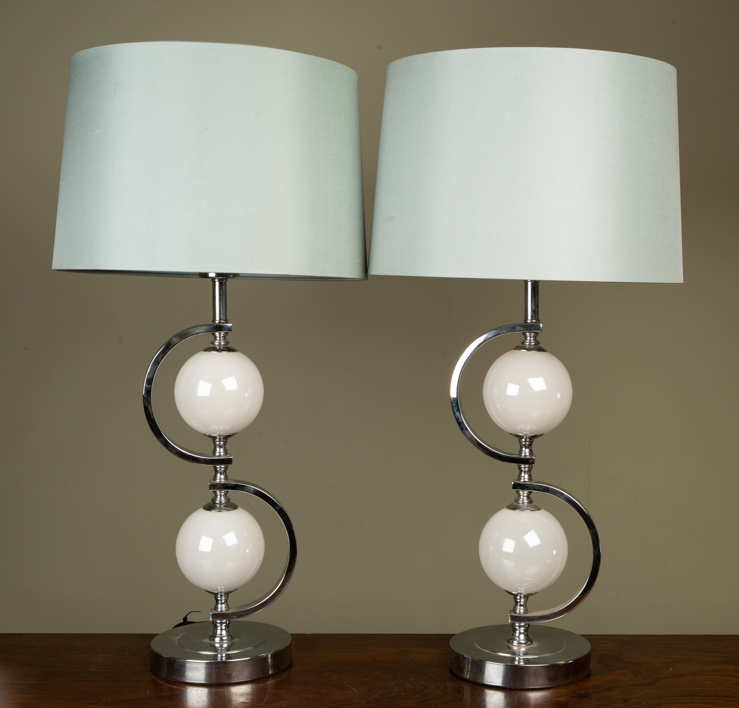 Appraisal: A pair of chrome and glass decorative table lamps with