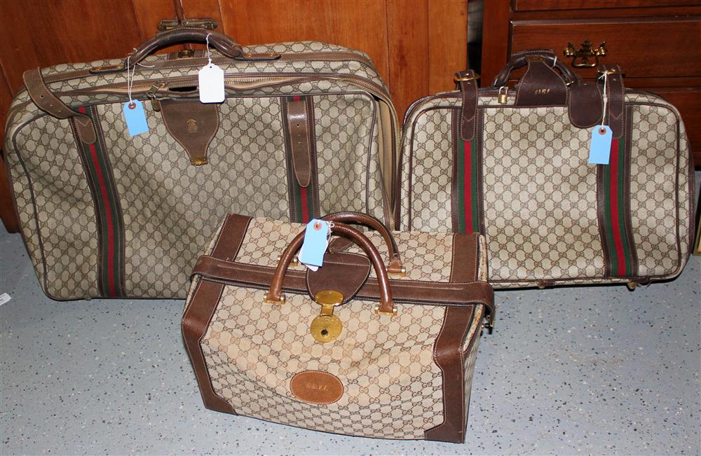 Appraisal: THREE PIECES OF GUCCI LUGGAGE the largest suitcase is h