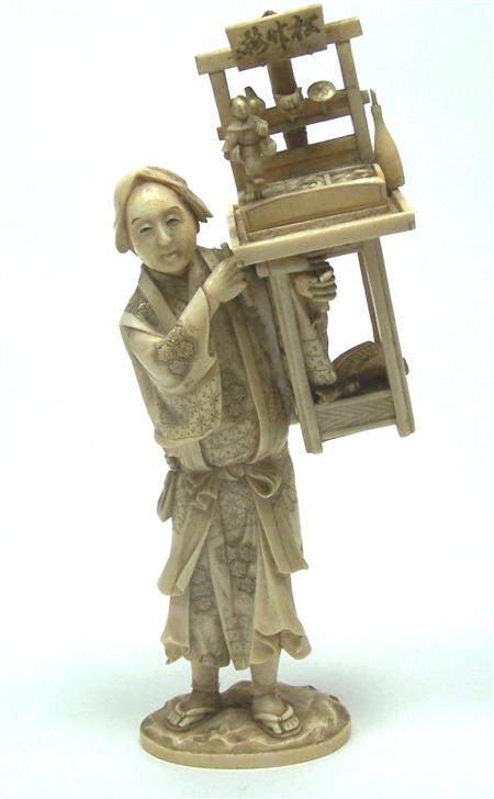 Appraisal: A Japanese ivory okimono of a figure with a puppet