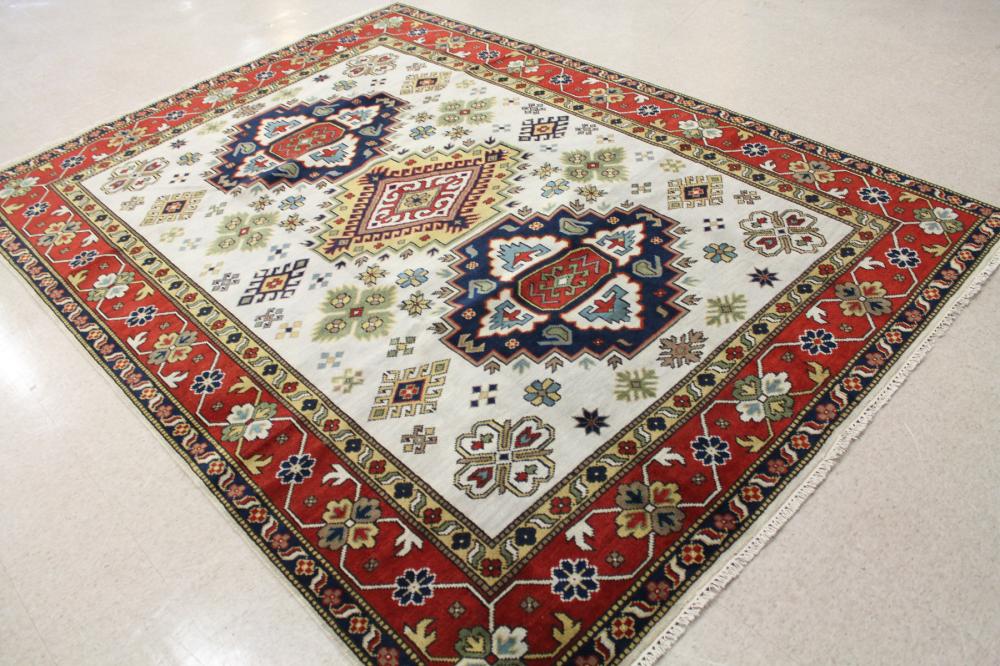 Appraisal: HAND KNOTTED ORIENTAL CARPET Indo-Caucasian triple geometric medallion design on