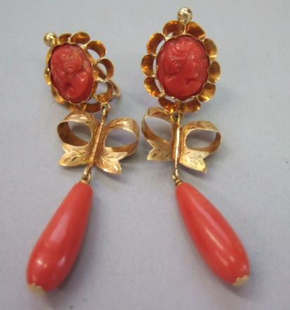 Appraisal: A pair of gold and coral pendant earrings each with