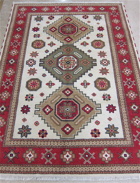 Appraisal: HAND KNOTTED ORIENTAL CARPET Caucasian design featuring a column of