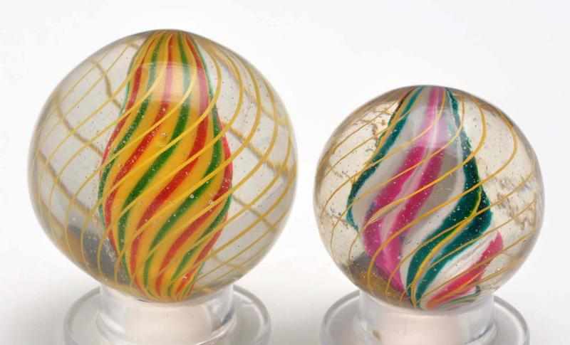 Appraisal: Lot of Solid Core Swirl Marbles Description The smaller marble