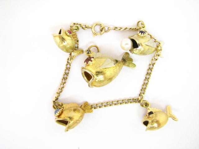 Appraisal: A K yellow gold fish charm bracelet with fish charms