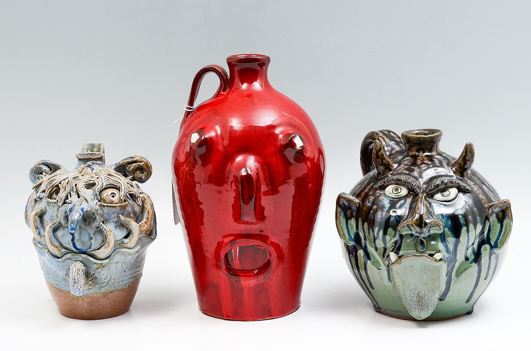 Appraisal: PC FOLK ART POTTERY FACE JUGS Comprising - Chris Phelps