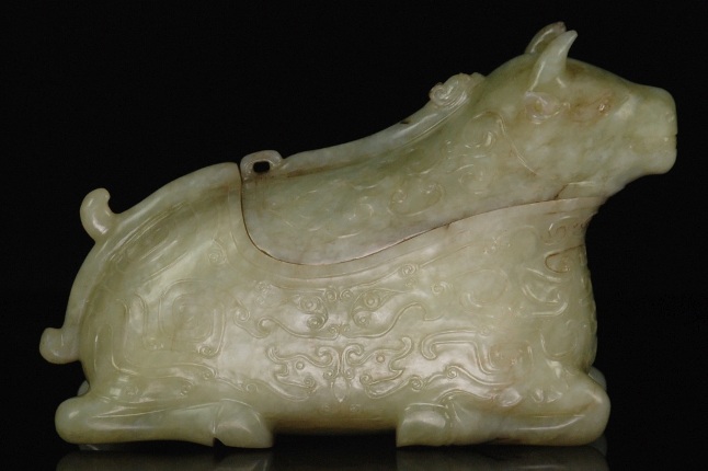 Appraisal: A representation of a recumbent bull the body carved with