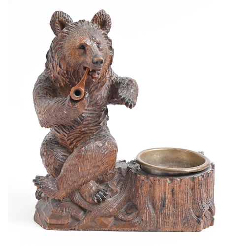 Appraisal: A Swiss anthropomorphic limewood ashtray in the form of a