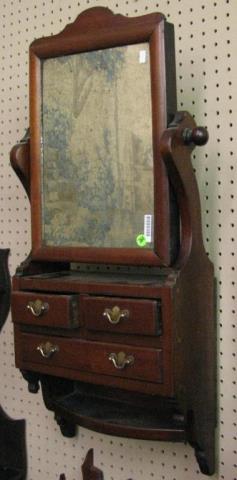 Appraisal: An antique mahogany wall shelf with shaving mirror three drawers