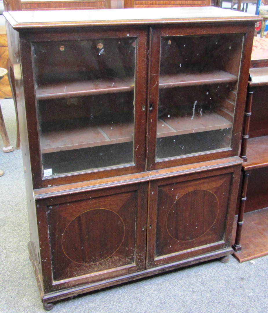 Appraisal: A miniature th century mahogany bookcase cupboard on bun feet