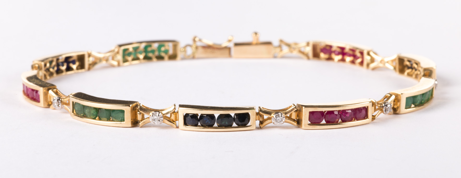 Appraisal: A Multicolored Gemstone Line Bracelet circular-cut emeralds rubies and sapphires