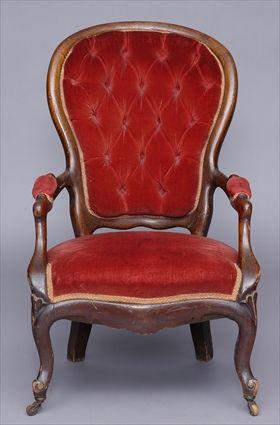 Appraisal: LOUIS-PHILIPPE CARVED WALNUT FAUTEUIL The cartouche shape tufted back flanked