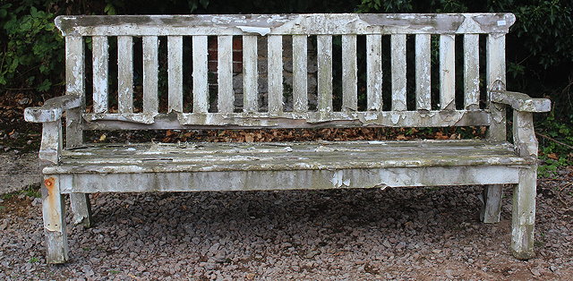 Appraisal: A LARGE WHITE PAINTED GARDEN SEAT with slatted back and