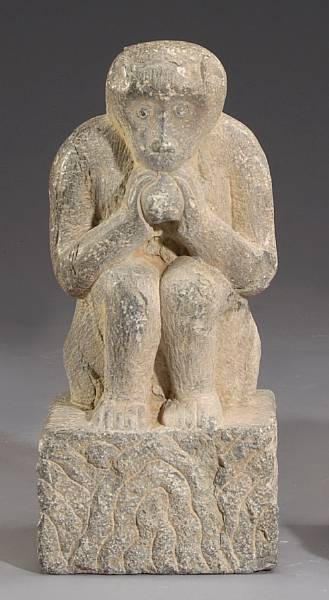 Appraisal: A grey stone figure of a monkey Shown holding a