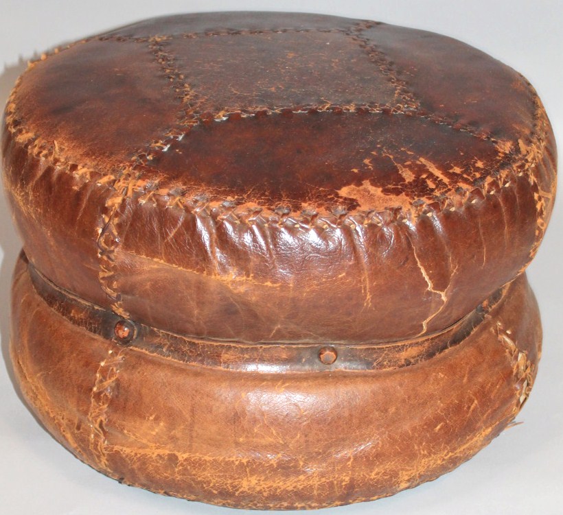 Appraisal: A thC leather pouffe of inverted circular form in brown