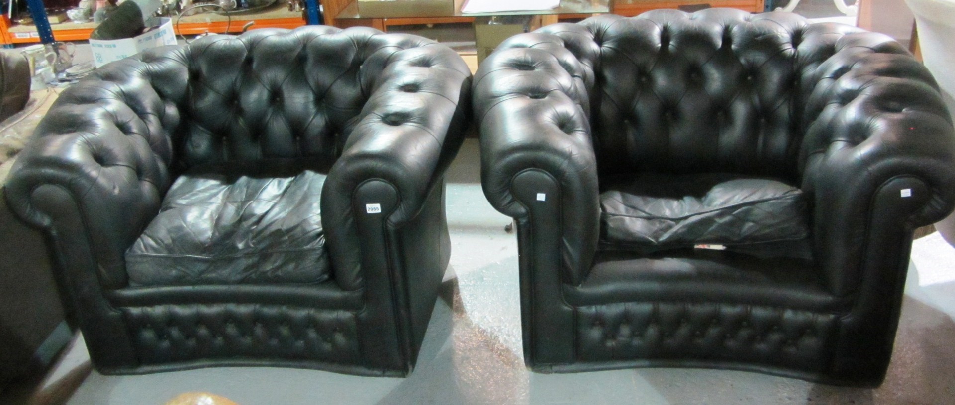 Appraisal: A pair of th century black leather tub chairs