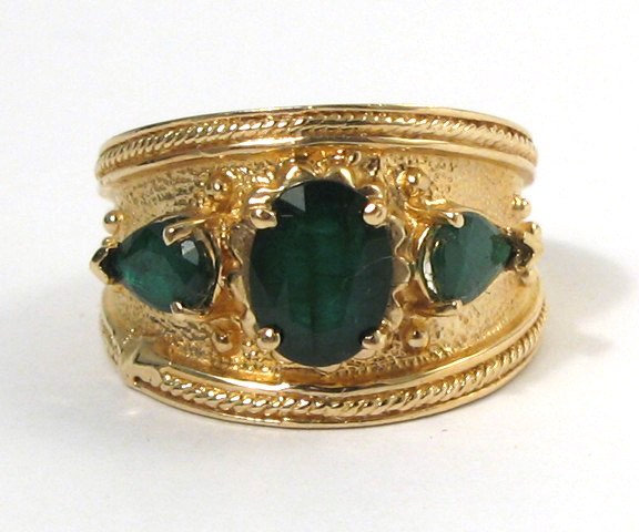 Appraisal: EMERALD AND FOURTEEN KARAT GOLD RING set with an oval-cut