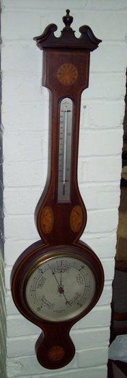 Appraisal: An Edwardian mahogany cased barometer and thermometer in a banjo