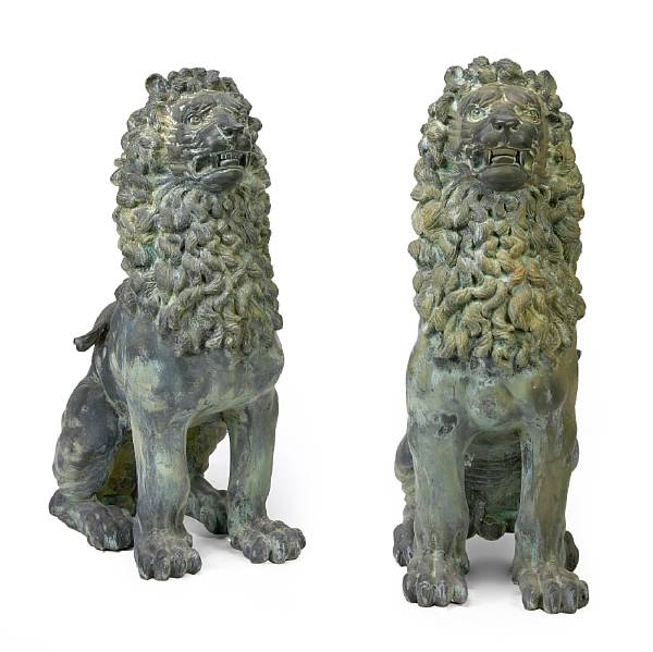 Appraisal: A pair of bronze models of seated lions Each seated