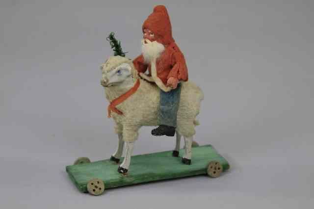 Appraisal: SANTA ON LAMB PLATFORM PULL TOY Painted composition heads Santa